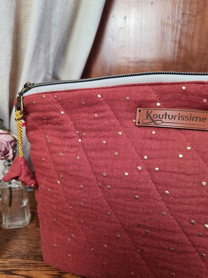 Détail de la fermeture zippée et de l’étiquette Kouturissime sur la trousse terracotta